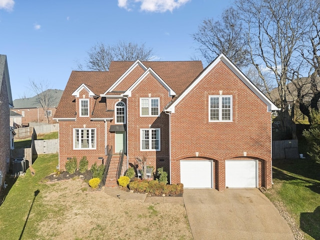 view of front of home featuring central air condition unit, a front lawn, and a garage