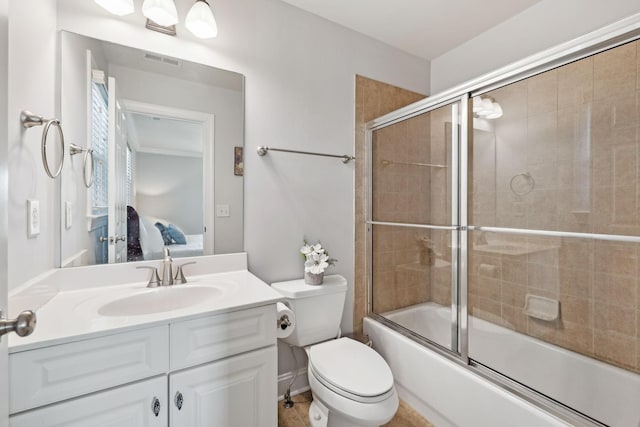 full bathroom featuring combined bath / shower with glass door, vanity, and toilet