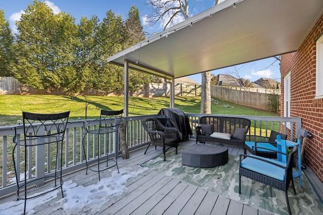 wooden deck with outdoor lounge area and a yard