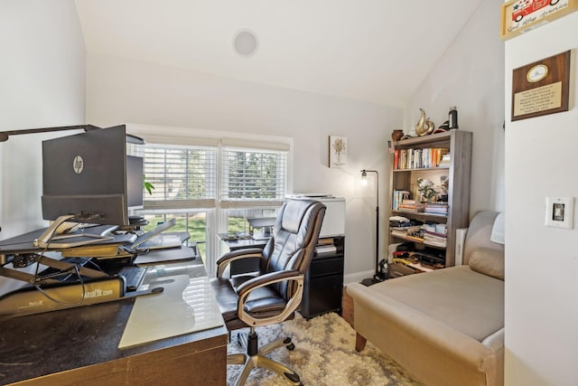 home office with lofted ceiling