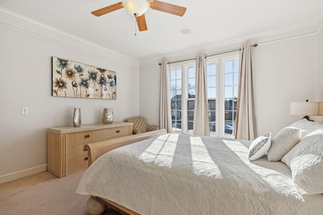 carpeted bedroom with ceiling fan and ornamental molding