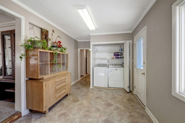 washroom with washing machine and dryer and ornamental molding