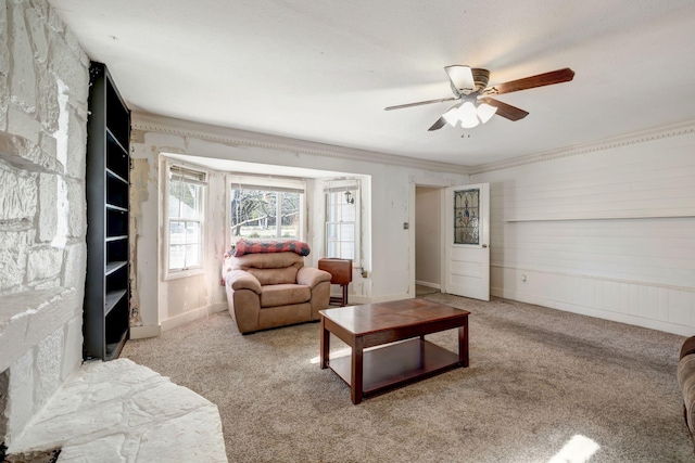 living room with ceiling fan, light colored carpet, and crown molding