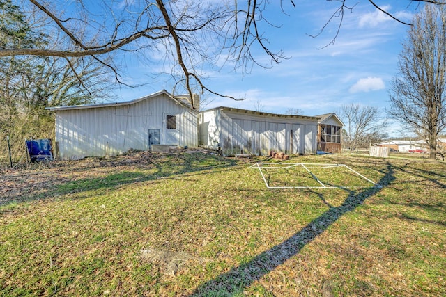 exterior space featuring a lawn and an outdoor structure