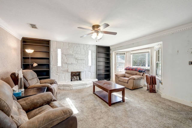 living room featuring ceiling fan, light colored carpet, built in features, a textured ceiling, and ornamental molding