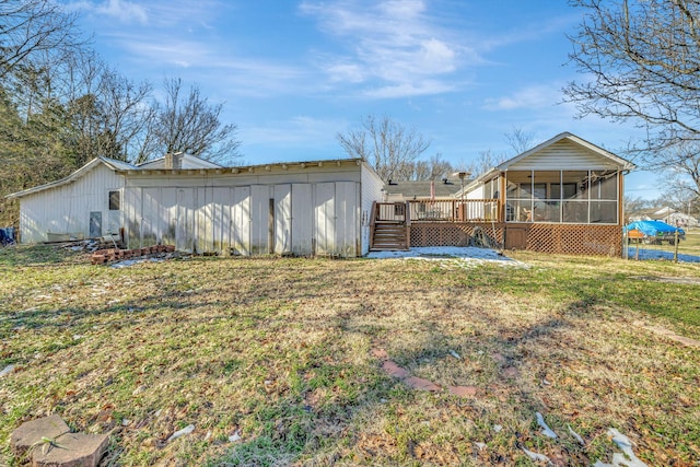 view of yard with a wooden deck and a sunroom