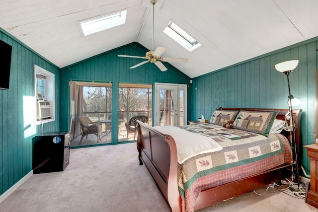 carpeted bedroom with ceiling fan, access to outside, vaulted ceiling with skylight, and cooling unit