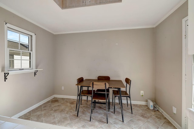 dining space with crown molding