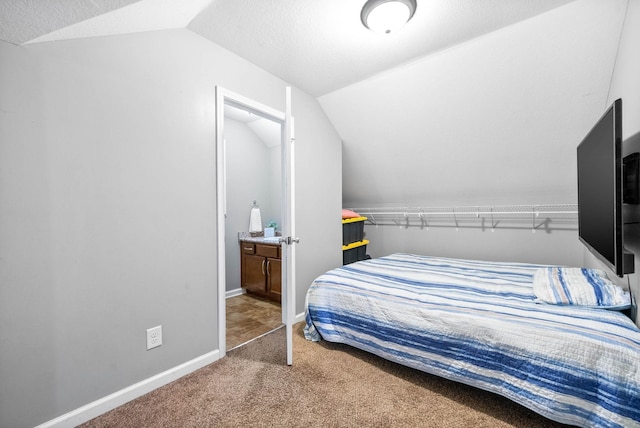 bedroom with carpet floors and vaulted ceiling