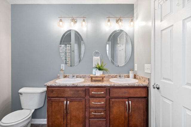 bathroom featuring toilet and vanity