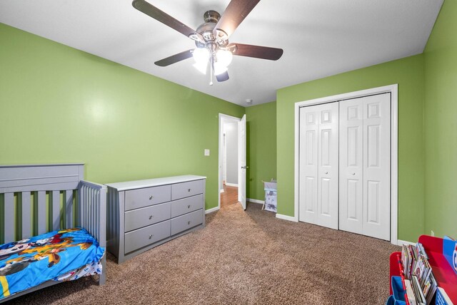 bedroom with ceiling fan, a closet, and carpet