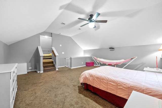 carpeted bedroom with ceiling fan and vaulted ceiling