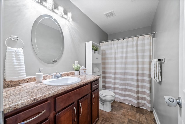 bathroom featuring toilet and vanity