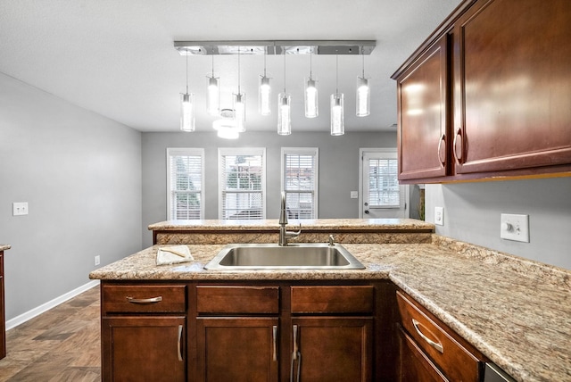 kitchen featuring sink, pendant lighting, and kitchen peninsula