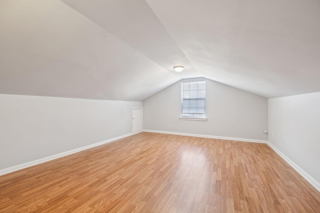 bonus room featuring lofted ceiling and light hardwood / wood-style flooring