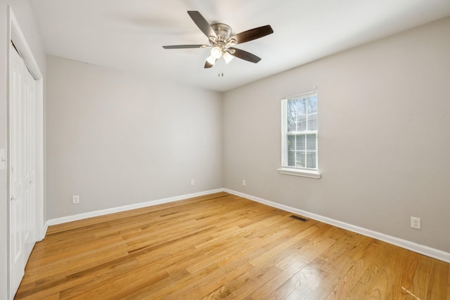 unfurnished bedroom featuring ceiling fan, light hardwood / wood-style flooring, and a closet