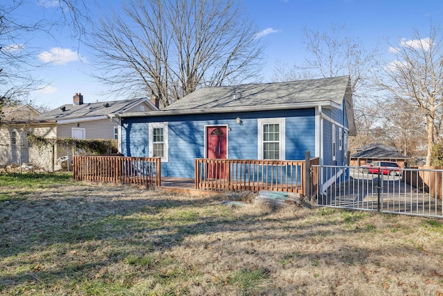 view of front of house with a front lawn and a wooden deck