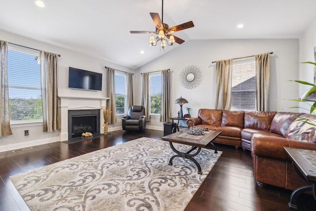 living room featuring plenty of natural light, dark hardwood / wood-style floors, and vaulted ceiling