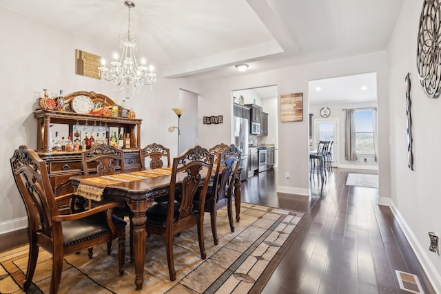 dining area with a chandelier and dark hardwood / wood-style floors