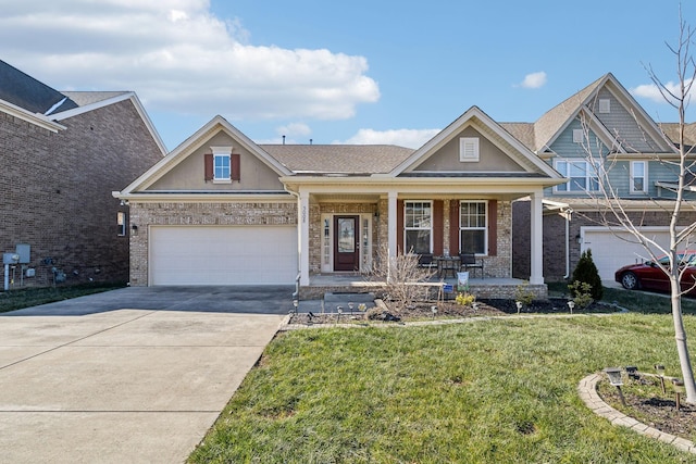 craftsman-style home featuring a front yard, covered porch, and a garage