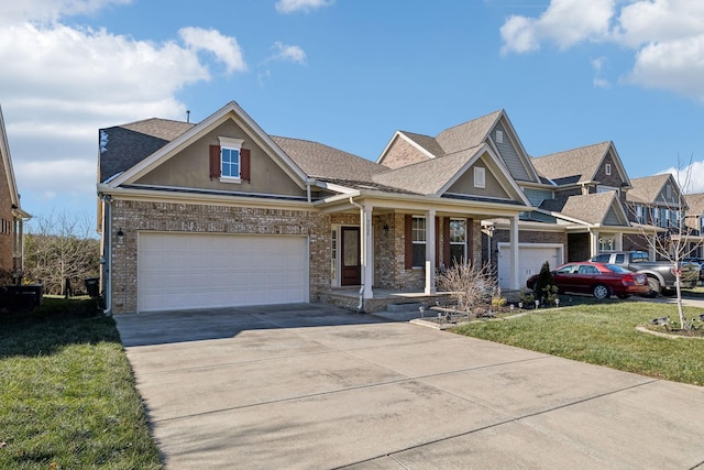 view of front of property featuring a front lawn, a porch, and a garage