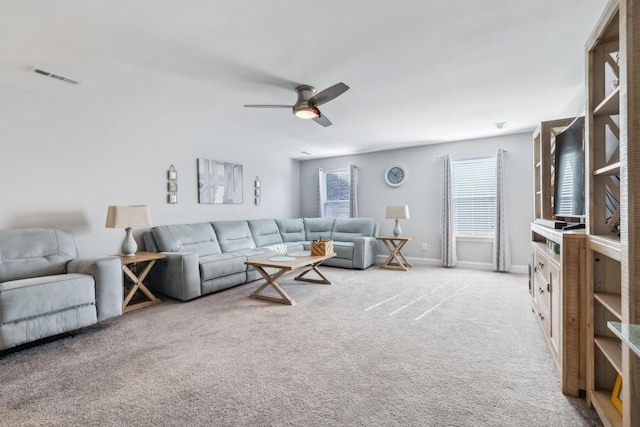 carpeted living room with ceiling fan