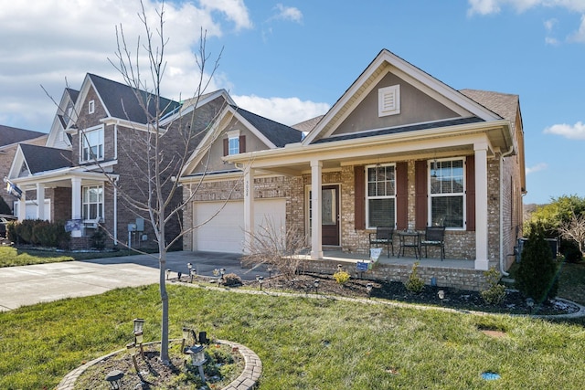 craftsman-style home featuring a front yard, a garage, and a porch