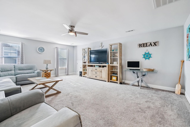 carpeted living room with ceiling fan