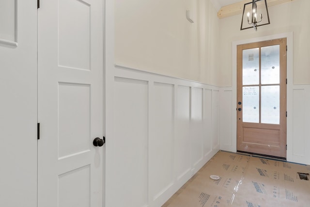 doorway to outside featuring a notable chandelier