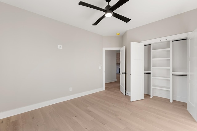 unfurnished bedroom with light wood-style flooring, baseboards, ceiling fan, and a closet