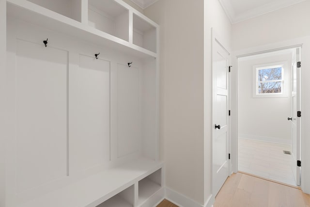 mudroom featuring baseboards, light wood-style flooring, and crown molding