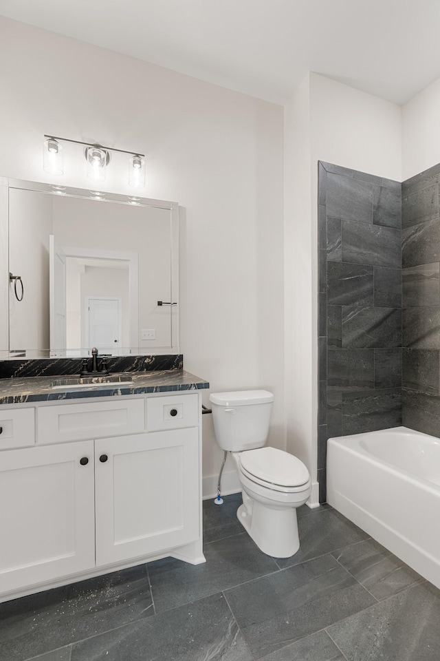 bathroom with toilet, washtub / shower combination, vanity, and baseboards