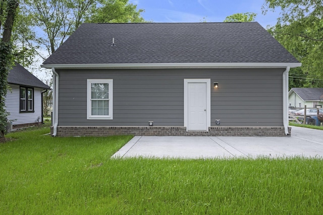 rear view of house with a patio area and a lawn