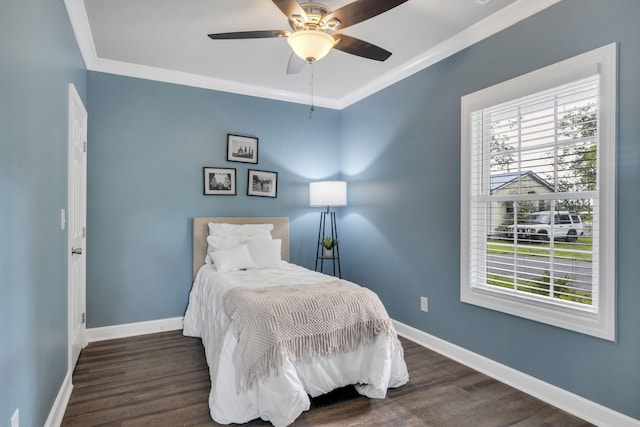 bedroom featuring ceiling fan, crown molding, and dark hardwood / wood-style floors