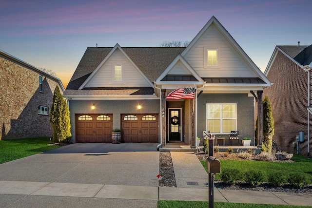 craftsman house with a garage, a lawn, and a porch