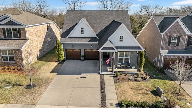 view of front of property featuring a garage, a front lawn, and a porch