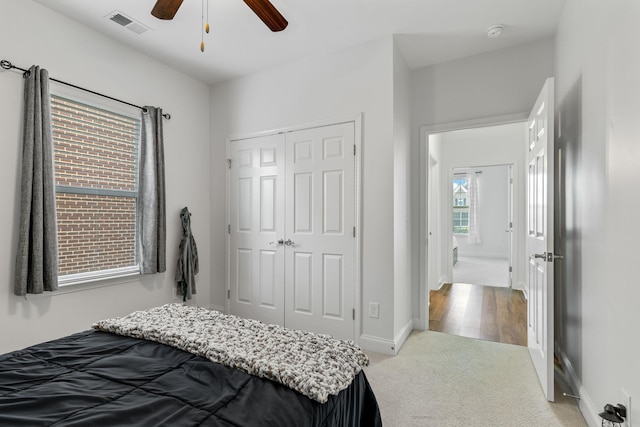 bedroom featuring ceiling fan, carpet, and a closet