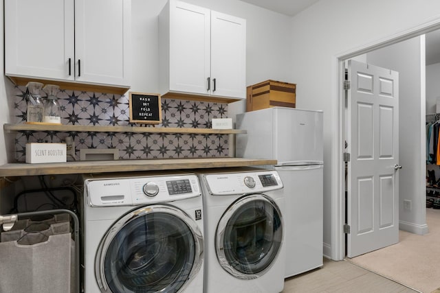 laundry room with cabinets and washer and dryer