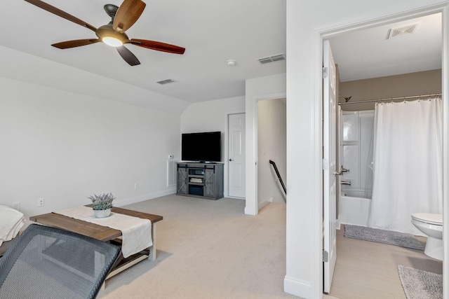 carpeted living room featuring ceiling fan and vaulted ceiling