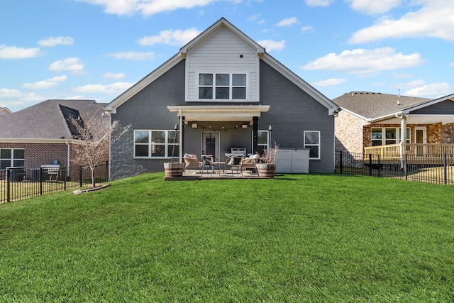 rear view of property with a patio and a lawn