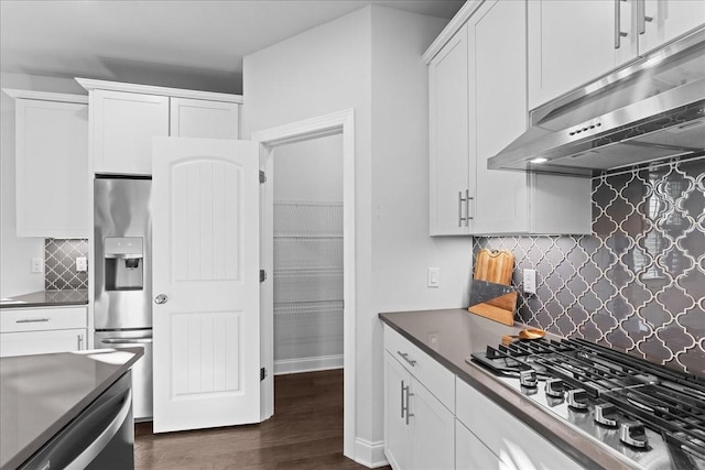 kitchen featuring backsplash, white cabinetry, and appliances with stainless steel finishes