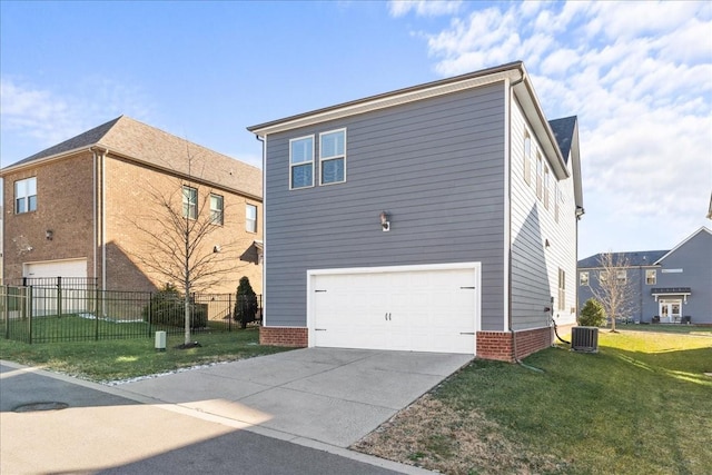 view of side of property with a garage, a yard, and central AC unit