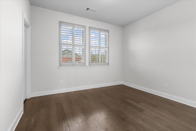 spare room featuring dark hardwood / wood-style flooring