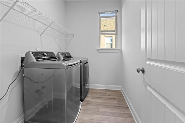 washroom with washing machine and clothes dryer