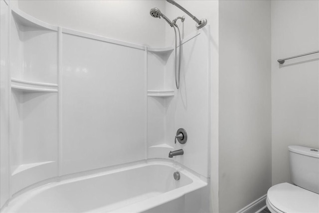 bathroom featuring shower / tub combination and toilet