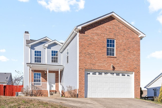 front of property featuring covered porch and a garage