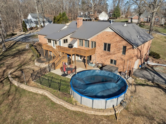 rear view of property with a patio area and a swimming pool side deck