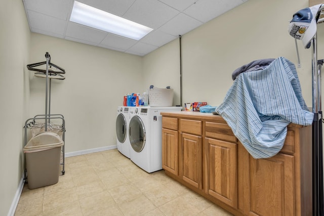 washroom featuring cabinets and washing machine and clothes dryer