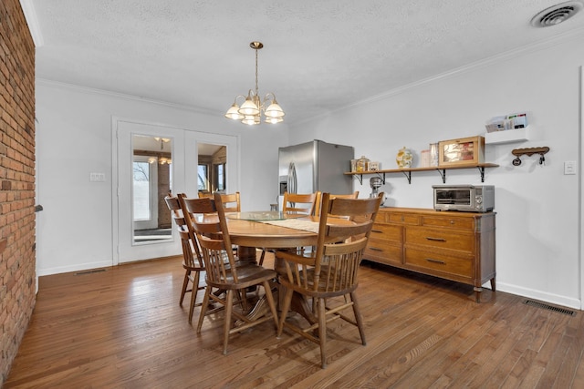 dining room with a chandelier, french doors, dark hardwood / wood-style floors, and a textured ceiling