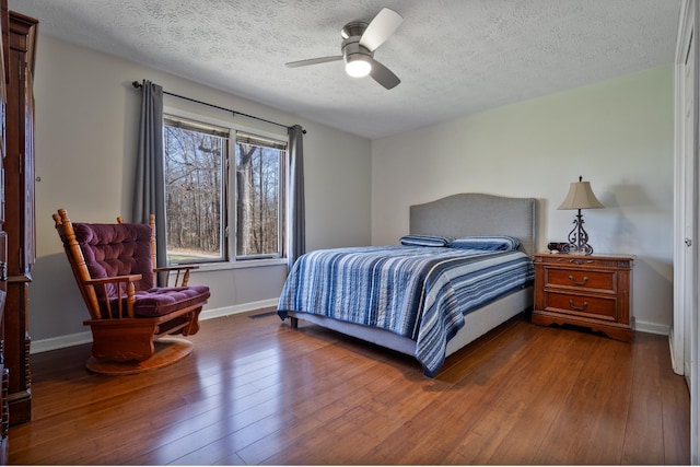 bedroom featuring ceiling fan, a textured ceiling, and hardwood / wood-style flooring